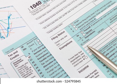 US 1040 Tax Form and silver ball pen over it