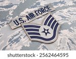 US AIR FORCE branch tape and Staff Sergeant rank patch on digital tiger stripe pattern Airman Battle Uniform background