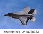 A US Air Force F-35A Lightning II creates condensation clouds shortly after takeoff.