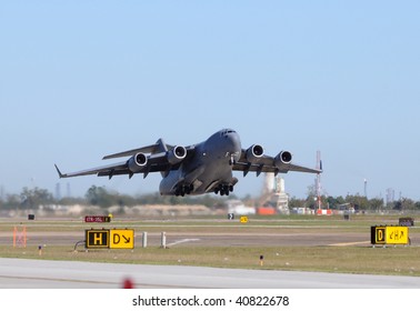 US Air Force heavy cargo jet taking off - Powered by Shutterstock