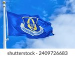 US Air Force Reserve Command flag against a blue sky and white clouds