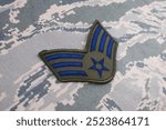 US AIR FORCE Senior Airman rank patch on digital tiger-stripe pattern Airman Battle Uniform background