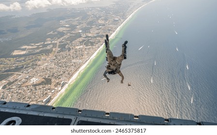 U.S. Airmen with the Air Force “Archangels” Special Warfare Exhibition Team perform a military free-fall operation over Panama City Beach - Powered by Shutterstock