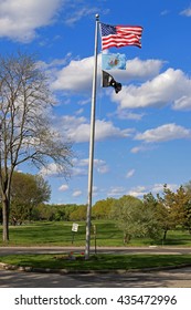 US American, Bergen County, NJ, And POW MIA Flags Waving In The Wind With The Beautiful Blue Sky In Background