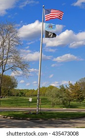 US American, Bergen County, NJ, And POW MIA Flags Waving In The Wind With The Beautiful Blue Sky In Background