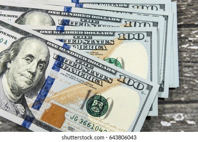 US American dollar money bills spread on wooden background - Shutterstock ID 643806043
