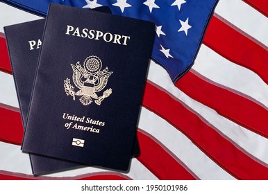 US American Passports acquisition after immigration citizenship exam over an American flag background.  - Shutterstock ID 1950101986