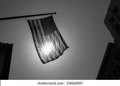 US american symbol flag over Black and white city urban shapes