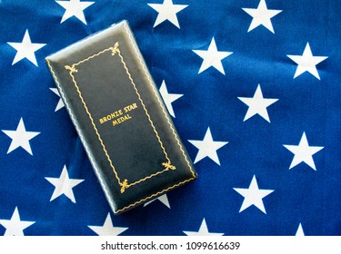 US Army Bronze Star Medal Display Case Lying On The American Flag