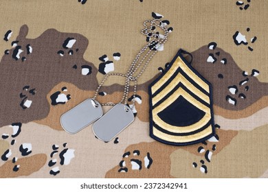 US ARMY Sergeant First Class rank patch and dog tags on Desert Battle Dress Uniform