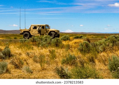 A U.S. Army Soldier, assigned to the 16th Combat Aviation Brigade, 7th Infantry Division, gets in a HUMVEE with Mount Adams in the distance during training at Yakima Training Center, Wash.