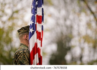 US Army soldier with US flag at a military parade