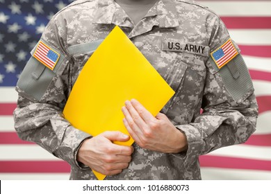 U.S. Army Soldier Holding Yellow Folder In Hands