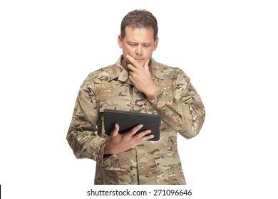 U.S. Army Soldier, Sergeant. Isolated. Looking Down At Digital Tablet.