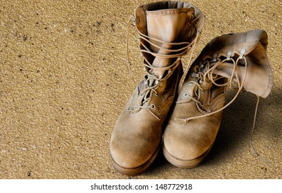 US Army Uniform Boots On Sandy Background (war Concept)