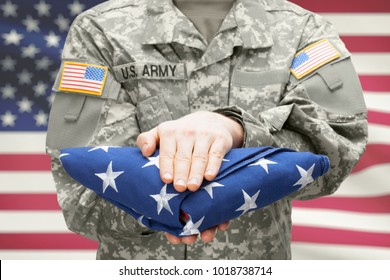 U.S. Army Young Soldier Holding Carefully Folded USA Flag Before His Chest