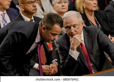 US. Attorney General Jeff Sessions talks with one of his aids prior the start of his testimony  in front of the Senate Intelligence Committee. Washington DC, June 13, 2017. (