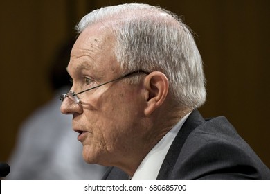 US. Attorney General Jeff Sessions peers over his reading glasses during his response to a question from members of the Senate Intelligence Committee during his testimony  Washington DC, June 13, 2017