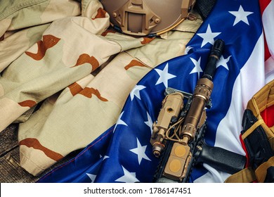 U.S. Battle Flag And Assault Rifle On The Wooden Table.