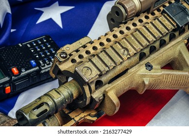 U.S. Battle Flag And Assault Rifle On The Wooden Table.