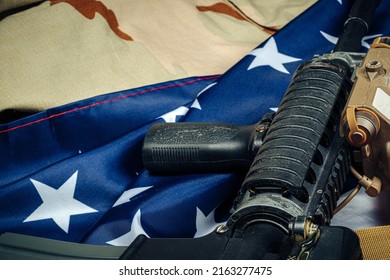 U.S. Battle Flag And Assault Rifle On The Wooden Table.