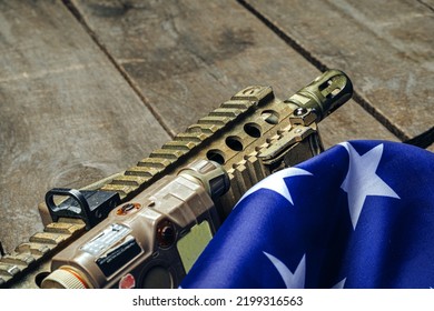 U.S. Battle Flag And Assault Rifle On The Wooden Table.