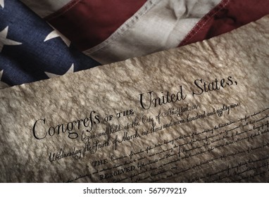 U.S. Bill Of Rights Document On An Old And Worn US Flag