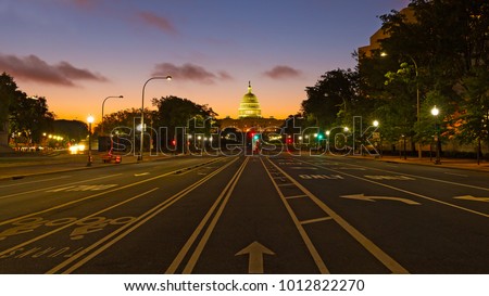 US Capitol building at dawn as seen from Pennsylvania Avenue. Colorful sunrise along Pennsylvania Avenue in Washington DC.