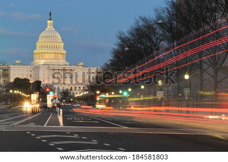 The U.S. Capitol building night view from from Pennsylvania Avenue with car lights trails - Washington DC, United States  