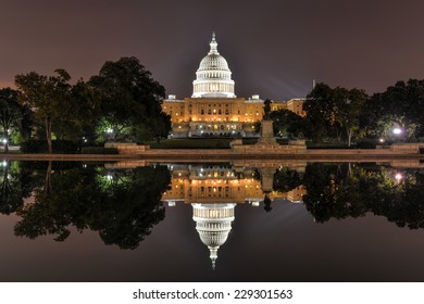 The US Capitol Building As Seen Across The Reflecting Pool At Night In Washington, DC.