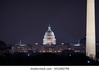 The US Capitol Building And The Washington Monument At Night.