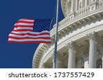 U.S. Capitol Dome  and waving US National flag close-up - Washington D.C. United States of America