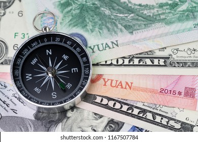 US And China Finance Economic Direction, Trade War, Import And Export Or World Economy Concept, Compass On US Dollar And China Yuan Banknotes, Tariff Deal Situation.