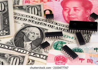 US And China Finance Trade War Concept. Semiconductor Chips On US Dollar And Yuan China Currency Banknotes. Microchip Shortage USA China Trade War