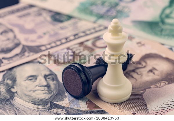 US and China finance trade war concept,\
black loser and white winner chess king on US dollar and china yuan\
banknotes, world major market\
countries.