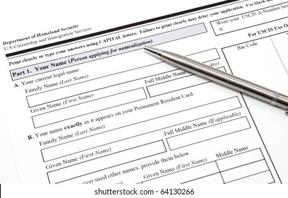 A U.S. Citizenship And Immigration Application With A Pen Ready To Be Completed.