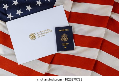 U.S. Citizenship And Immigration Services Of Naturalization With USA Passport Over U.S. Flag
