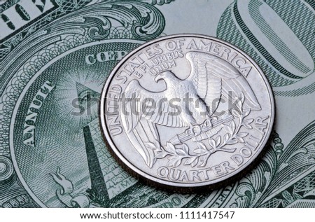 US coin quarter dollar on one dollar bill. Obverse of the coin 25 US cents on a banknote 1 US dollar
