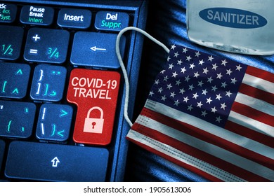 US COVID-19 Coronavirus Travel Restrictions Concept Showing Red Button Warning On Keyboard With American Flag Face Mask And Hand Sanitizer. New Normal In Global Travel.