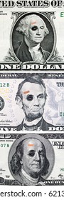 US Currency With Black Eyes And Band Aids Concept Of Bad US Economy