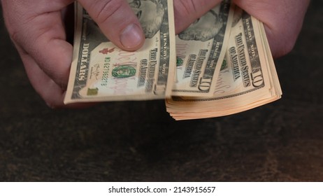 US Dollar. American money. Worldwide money. Man's hand counting dollars
