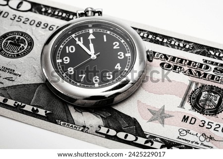 US dollar banknote with a clock showing five to twelve
