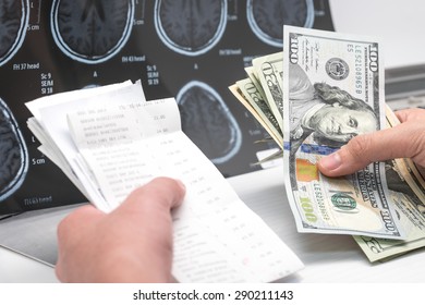 US Dollar Banknotes And Bill With Brain X Ray Film For Medical Expense Background