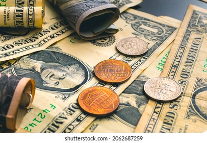 US dollar banknotes and few cents in closeup photo.
				