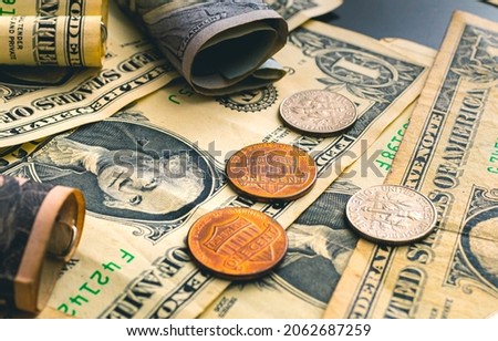 US dollar banknotes and few cents in closeup photo.
