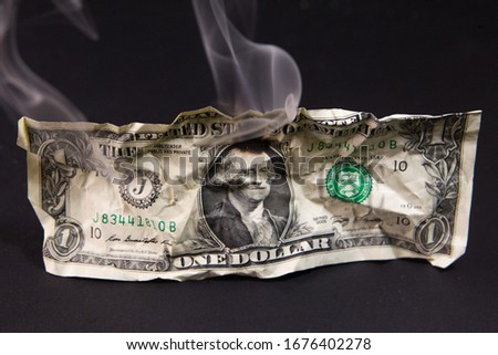 US dollar bill . Burning dollar bill . The dollar is burning