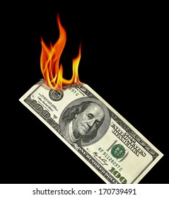 US Dollar bill burning in fire flame isolated on black background