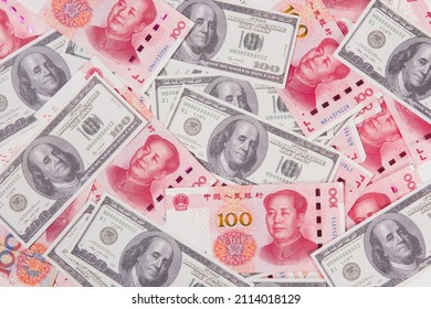 US Dollar Bill And Chinese Yuan Banknote. USD Vs RMB.