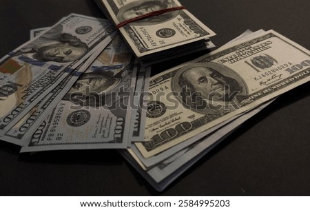  US Dollar bills bundles stack on black background. A pile of one hundred US banknotes with president portraits. Cash of hundred dollar bills, dollar background image with high resolution