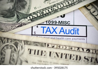 US dollar bills on tax form suggesting tax payment or audit - Shutterstock ID 395028175